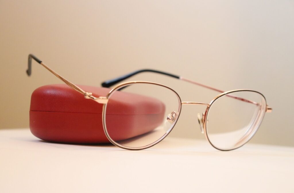 Close up photo of a pair of eyeglasses resting on an eyeglass case