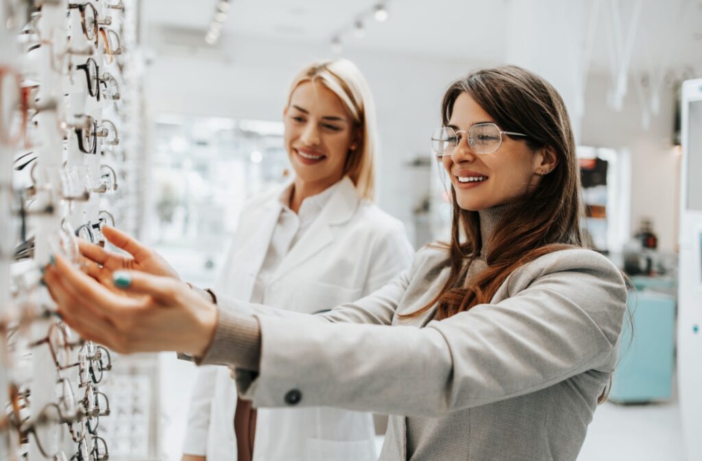 An optometrist helps a patient pick out a new style of glasses after an eye exam to get an updated eyeglasses prescription