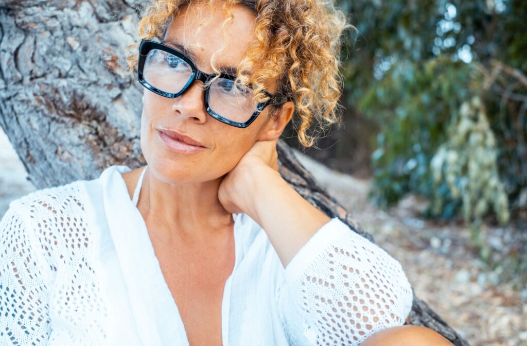 A woman wearing a pair of thick rimmed glasses that are currently trendy